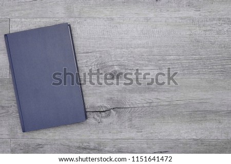 A studio photo of a hard cover book