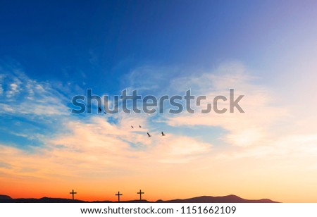 Christ Jesus birth and resurrection concept :Silhouette cross on Calvary mountain sunset background