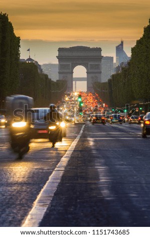 sunset scene in Paris city. Long exposure photo of street traffic near Arc de Triomphe, Champs Elysees boulevard.