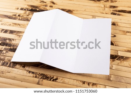 Mockup of white booklet on bamboo background