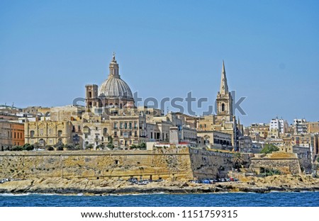 the blue Mediterranean sea and a Malta city view with a blue sky background
