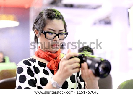 The Asian woman taking food photo.