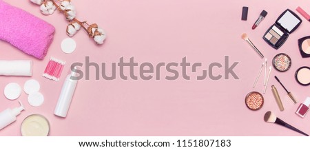 Make-up Remover Accessories. Flat lay background with cotton branch, cotton pads, ear sticks, cosmetic bottle containers, pink towel, various make-up cosmetics, mascara, powder, lipstick, eyeshadow. Royalty-Free Stock Photo #1151807183