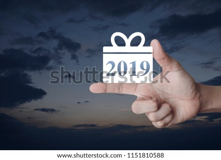 Gift box happy new year 2019 icon on finger over sunset sky, Business shopping online concept