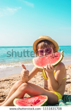 a child at sea eating a watermelon. selective focus. nature.