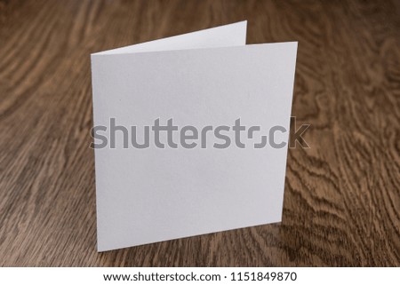 Mockup of white booklet on wooden background