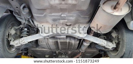 The lifted car in the car repairing workshop,Auto service shop has lift for easy working on underside of car, tools for repair Royalty-Free Stock Photo #1151873249