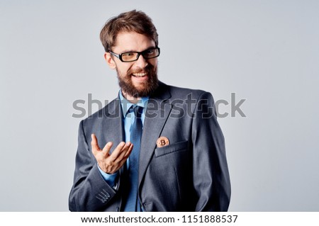 business man in a blue shirt and glasses, coin in a jacket                               