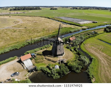 aerial views from rural Holland, mill, green field, Netherlands, summer 2018
