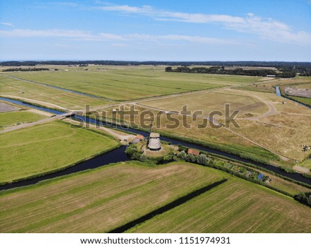aerial views from rural Holland, mill, green field, Netherlands, summer 2018