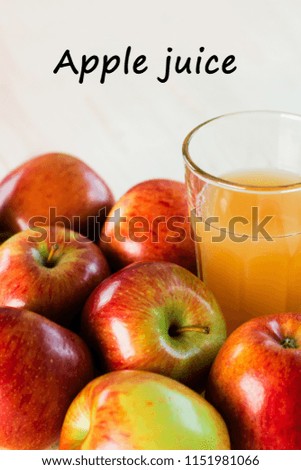 Glass of fresh apple juice near autumn apples. Wooden background, top view, text apple juice.