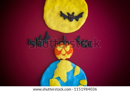 Happy Halloween. The Moon, Earth, pumpkin and bats are made out of modeling clay.