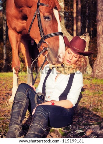 Beautiful  cowgirl with her red horse