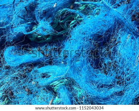 Close up of blue fishing net used for commercial fishing in the UK