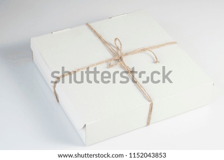 White packing box for transportation of food on a white background. Context - environmentally friendly packaging.