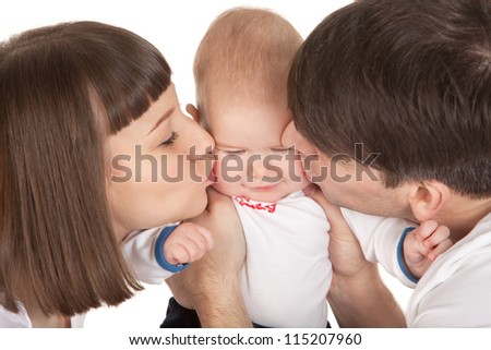 closeup picture of happy parents kissing their baby boy isolated over white background