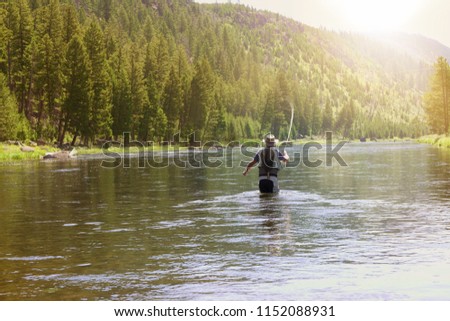 Fisherman flyfishing in river of Montana state Royalty-Free Stock Photo #1152088931