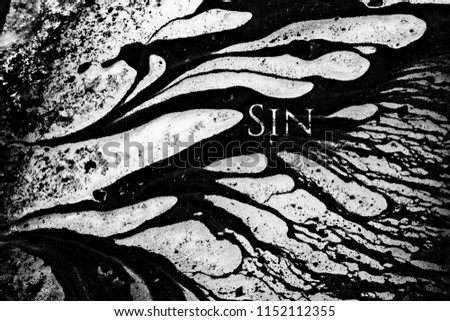 Abstract concept of Sin with uppercase font, contrasted on ice