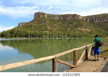 Young man taking pictures of nature in the lagoon of Uña, a village near Cuenca, in Castilla la Mancha, Spain