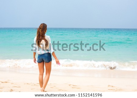 Beautiful Young Girl Looks on Sea Long Hair Blowing in the Wind Summer Holiday Time Royalty-Free Stock Photo #1152141596