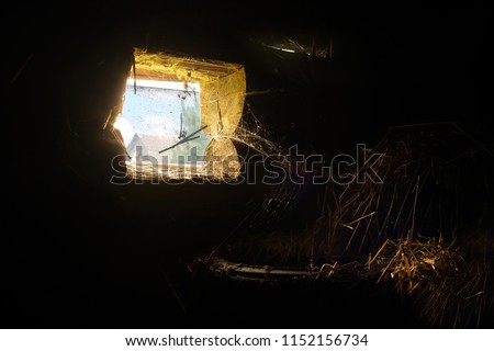 A window in an old wooden barn