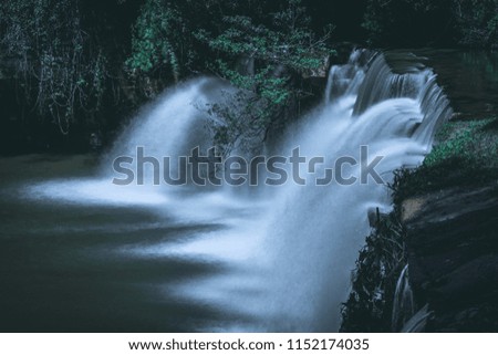 Waterfall with slow speed shutter and adjusted picture style with dark green tone
