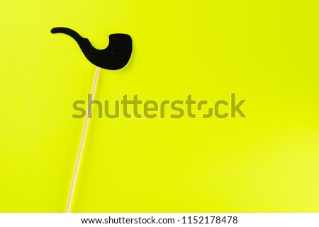 Happy fathers day,birthday party, Purim, Halloween concept.  Black paper smoking pape with copy space for text on yellow background.Top view.