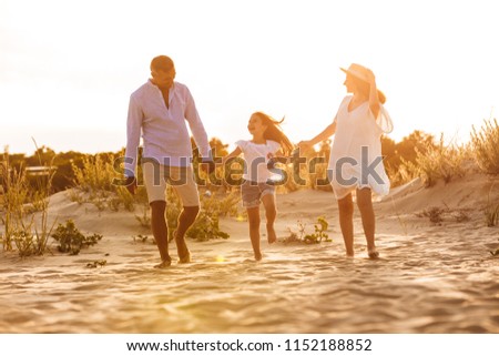 Picture of young happy family having fun together at the beach.