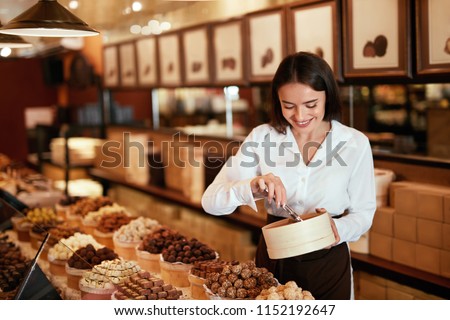Chocolate Store. Woman Working In Chocolate Shop Royalty-Free Stock Photo #1152192647