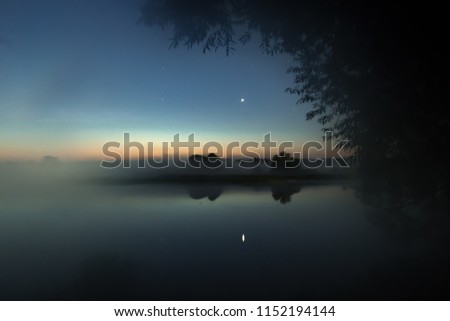 Astrophotography - the planet Venus is reflected in the water by a foggy morning