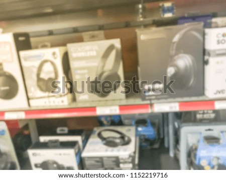 Blurred background headphones on display for sale at electronic store in Texas, USA