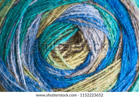 Knitting. Multi-color coil of natural wool yarn, coiled with hands