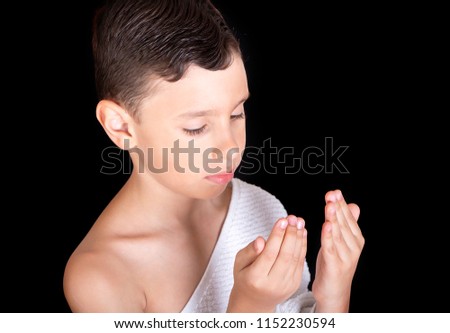 Cute Muslim Kid Praying While Wearing Ihram ( White Traditional Islamic Clothes ) During Hajj Royalty-Free Stock Photo #1152230594