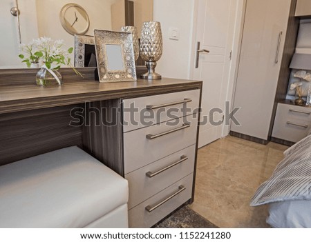 Interior design decor furnishing of luxury show home bedroom with dressing table and double bed