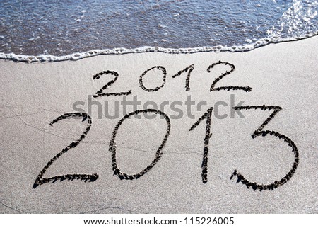 Happy New Year 2013 replace 2012 concept on the sea beach