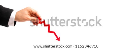 A businessman's hand is holding a red arrow down on a white background. concept of reducing costs and profits, falling living standards and prices. Decreased projections, depressed economies. banner
