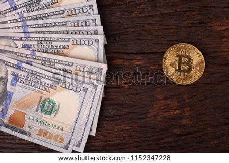 Beautifully arranged bills 100 dollar and gold coin bitcoin on a gray background. Bitcoin cryptocurrency. Anonymous. Background for your text and design