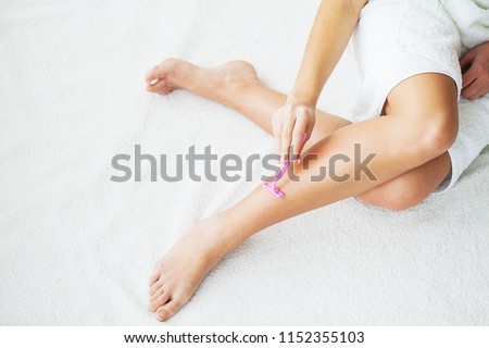 Skin Care and Health. Hair Removal. Fit Woman Shaving Her Legs With Razor. Royalty-Free Stock Photo #1152355103