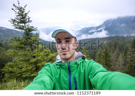 Man in green jacket doing selfie outdoor