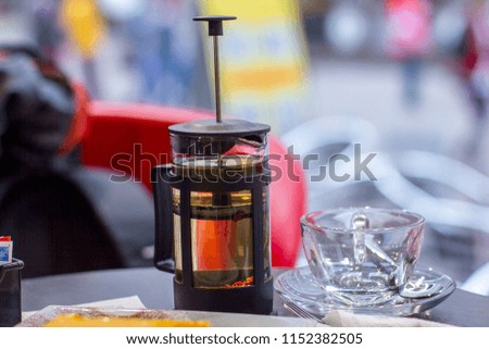 Transparent teapot of green tea on the table