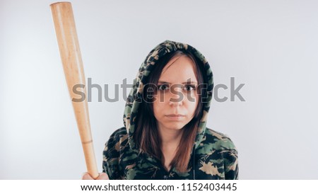 Young cute girl with baseball bat, Girl with a bat. girl or criminal woman, holding baseball bat in hand.  Sport and training