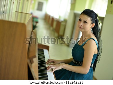 beautiful young woman playing the piano