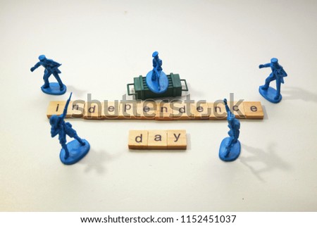 A close up picture of army miniature with word tiles creating independence day. Independence is something precious need to protect by all people.