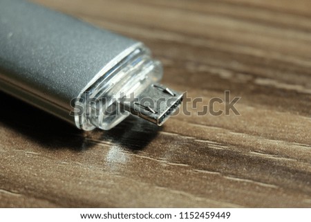 A close up picture of mini usb from a pen drive on a table in the office.