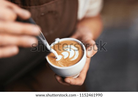 Coffee Art In Cup. Closeup Of Hands Making Latte Art 