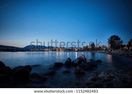 Evening downtown Vancouver with reflection lights in water