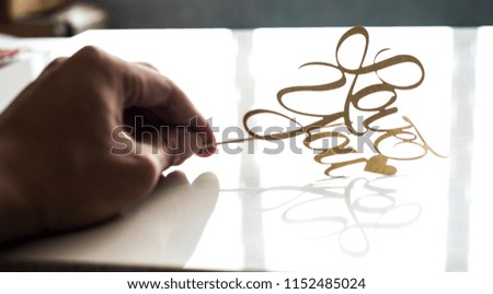 Hand holding Golden love you word over white background