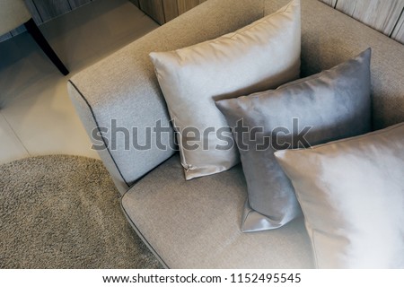 soft cozy pollows on modern sofa with wooden background home design concept