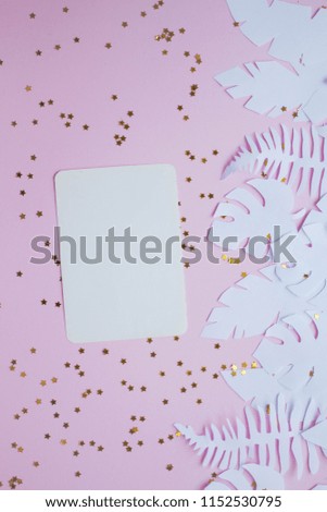 mockup card with tropical leaves. invitation card with environment and details Mockup with postcard and handmade paper leaves on pink background.