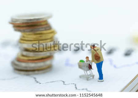 Miniature people: Shopper in shop mall with shopping cart. Image use for background business, marketing concept.